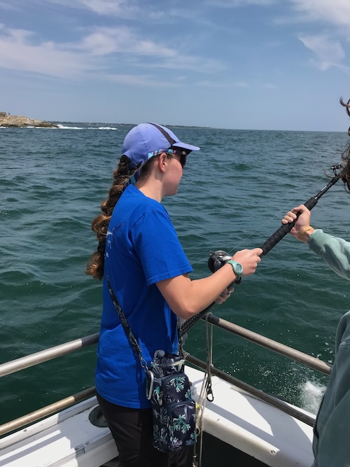 Me holding a fishing rod on a boat